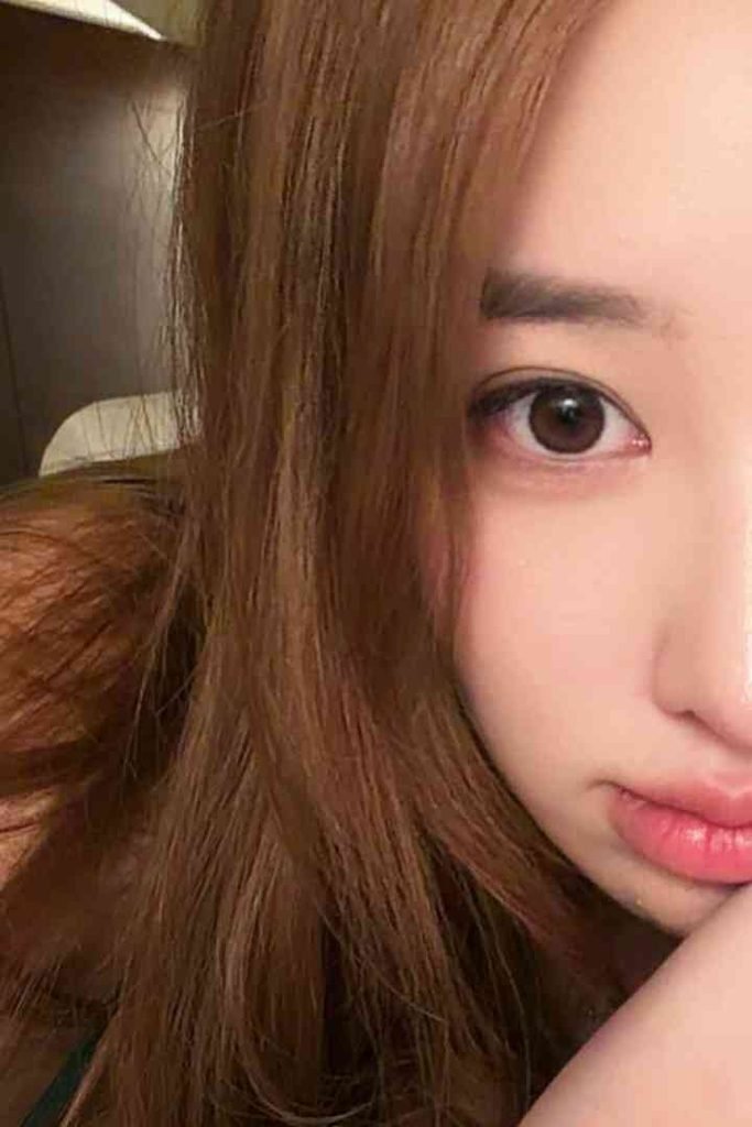 KL Escort Girl Close-up of a young woman with brown hair and brown eyes, looking at the camera. Malay Escort
