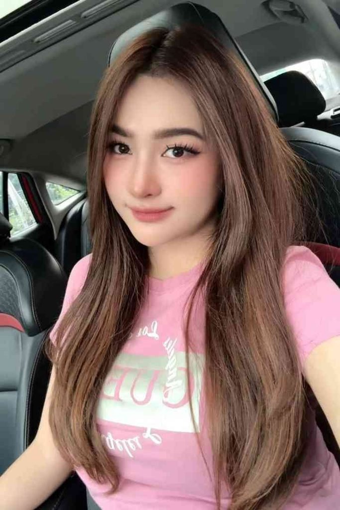 KL Escort Girl Young woman with long brown hair wearing a pink t-shirt Malay Escort