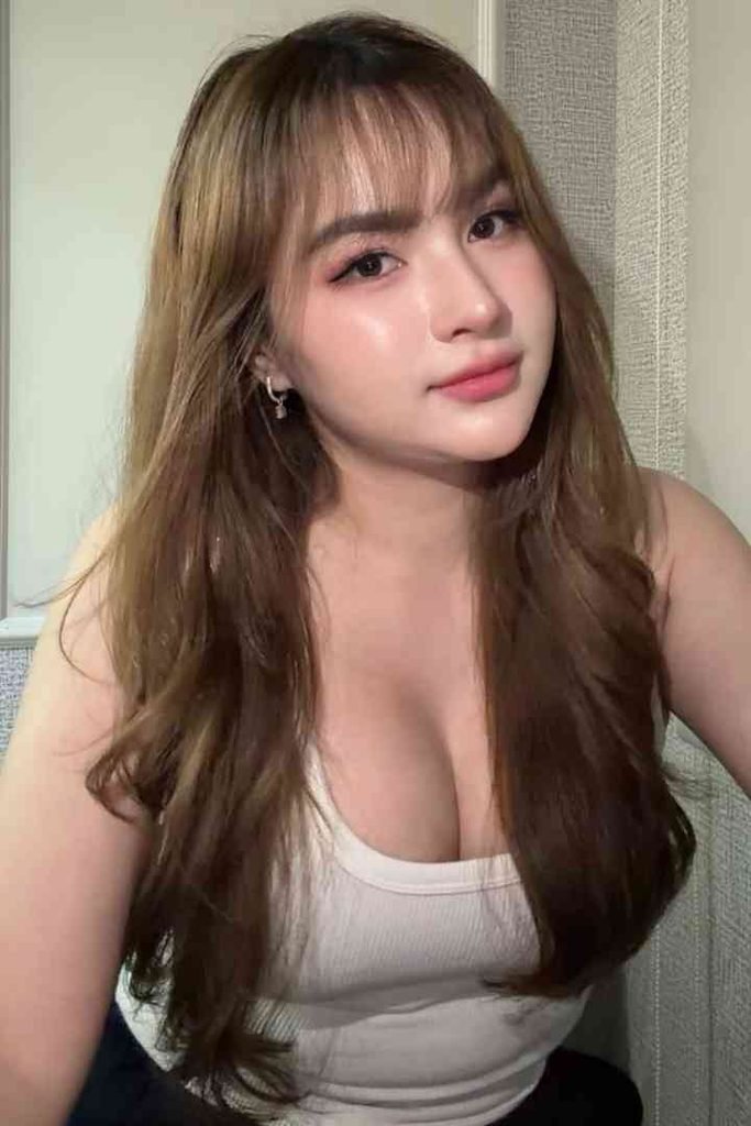KL Escort Girl Isya, a premium Malay escort, poses in a white tank top. Malay Escort
