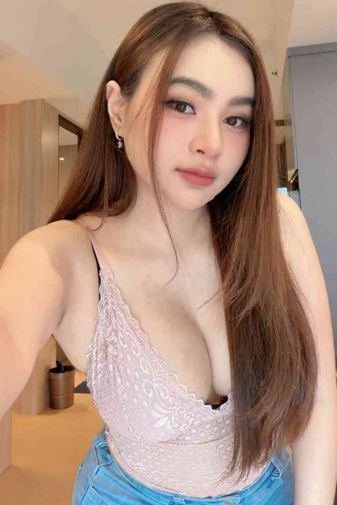 KL Escort Girl Young woman with long brown hair and a pink lace top Malay Escort